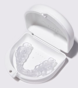 Clear dental aligner in a white storage case.  If you need further assistance, feel free to as